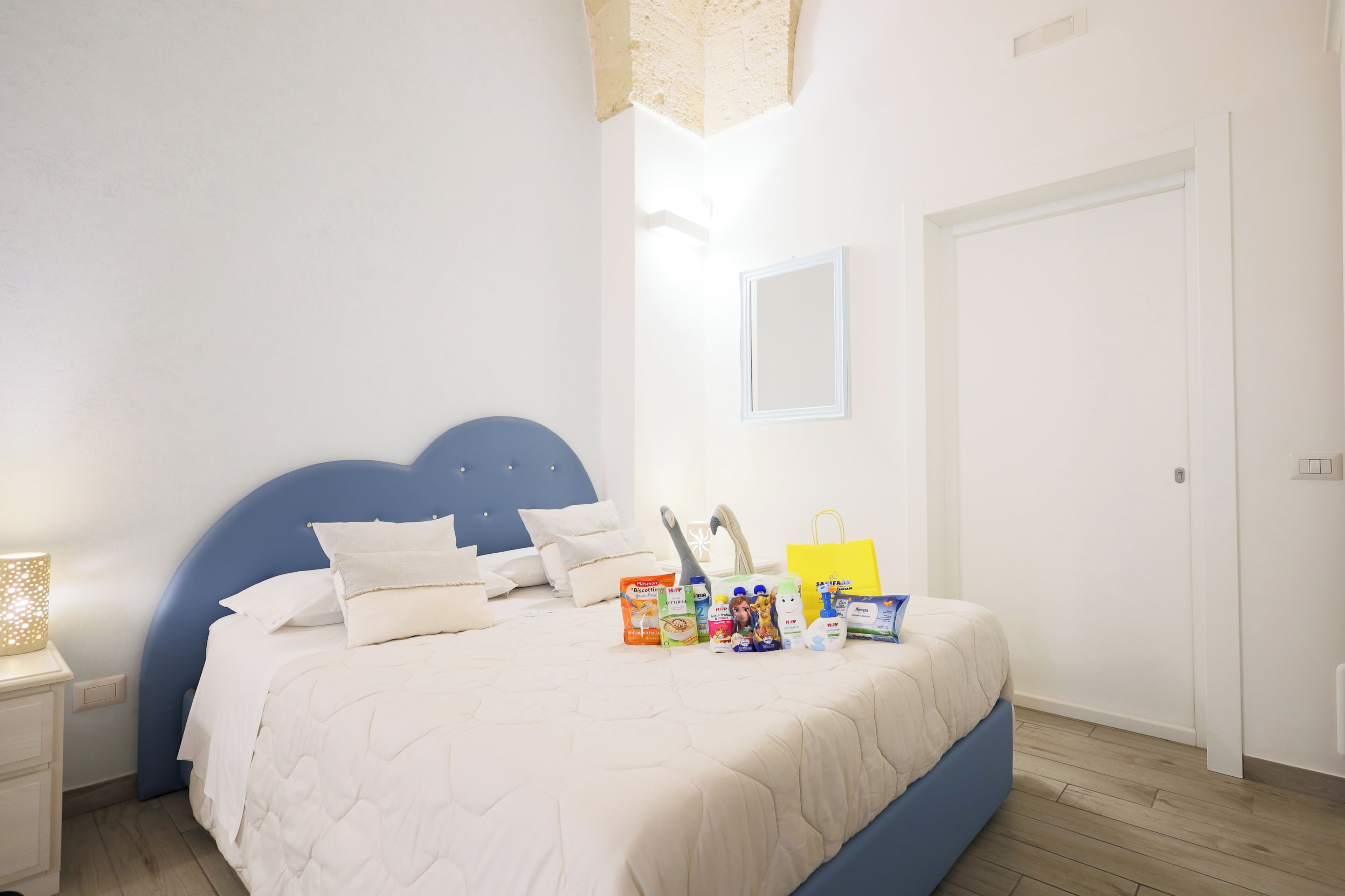 A bedroom with a bed, bedside table, and a nightstand.