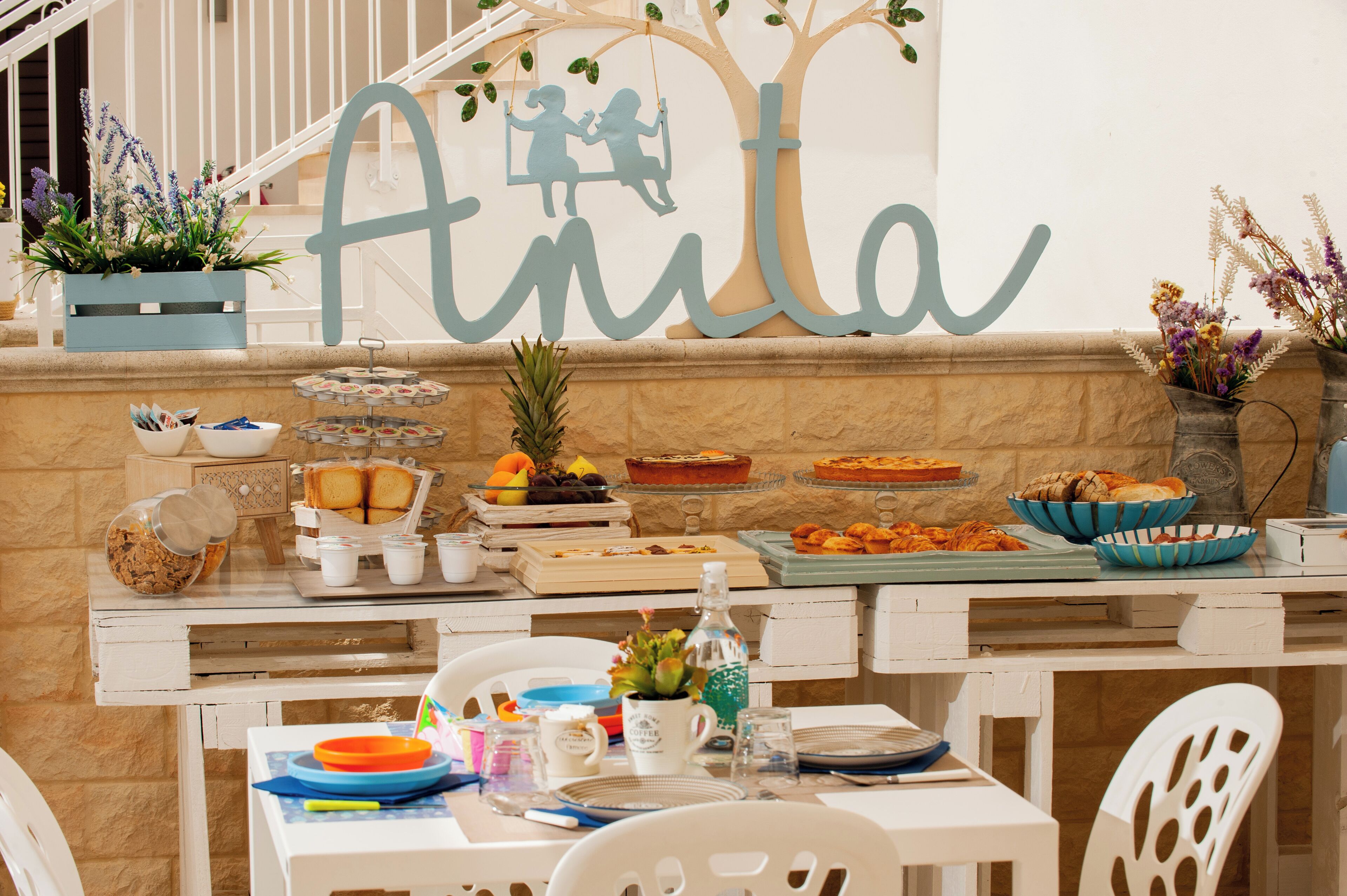 A breakfast buffet with various food items and a decorative sign above.