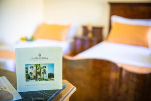 A brochure titled "LA RESIDENZA TORCHIARA" on a table in a hotel room. - La Residenza Torchiara (Torchiara)