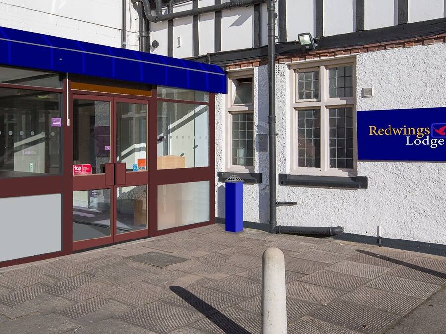 A Redwings Lodge building with a blue awning, large windows, and a sign on the wall.