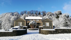 A stone building with a snow-covered roof and a clear blue sky. - Inch Schoolhouse - Event Residence (Downpatrick)