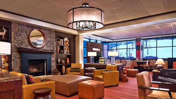 A spacious lobby with a fireplace, comfortable seating, and large windows offering views. - Sheraton 3BR, 3BA: New Years Week- Top Fl. Direct on Mountain & 100% Ski-In/Out! (Steamboat Springs)