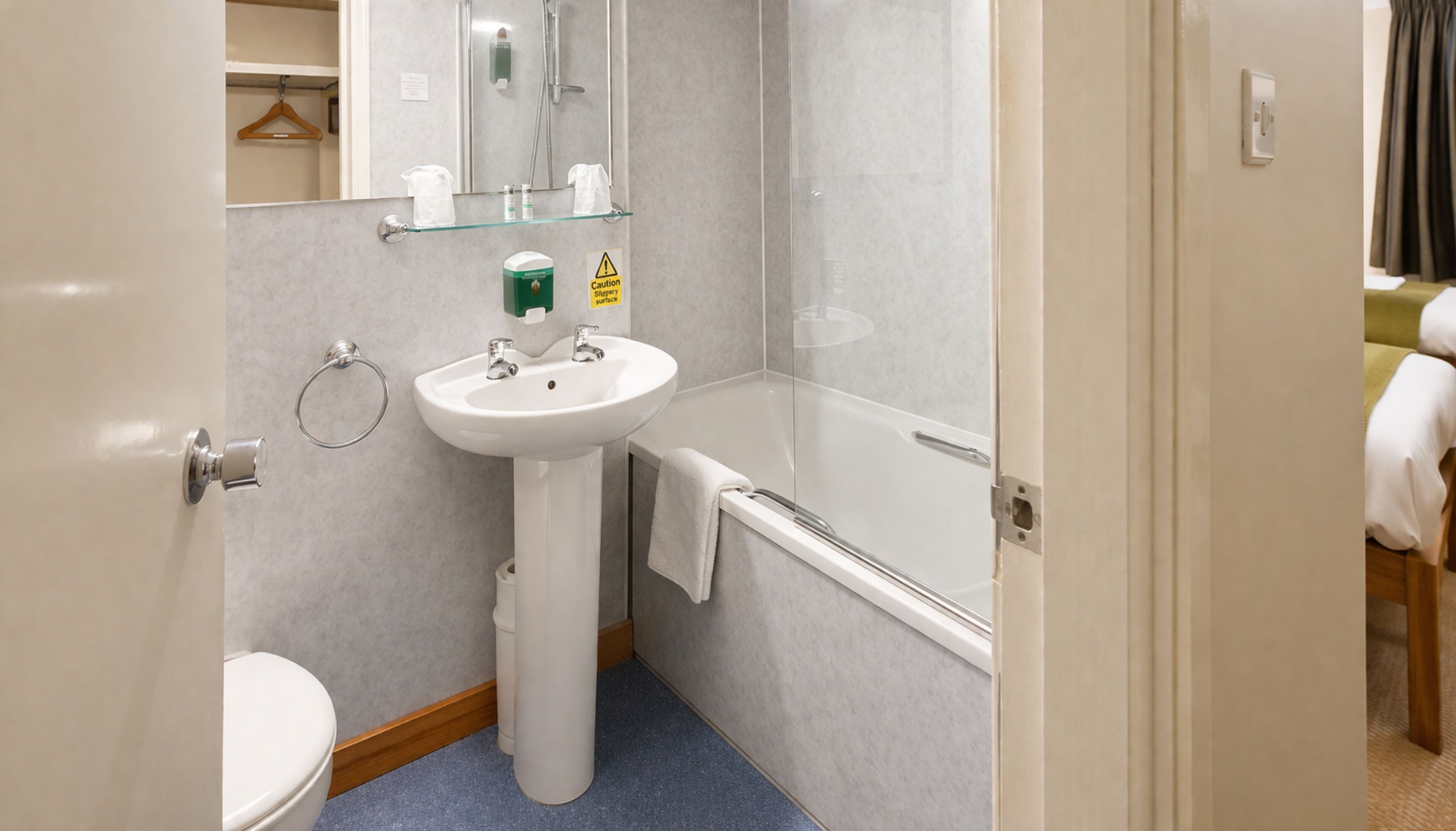 A bathroom with a sink, toilet, and bathtub.