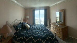 A bedroom with a bed, dresser, mirror, lamp, and a television. - August Hot Summer Special On The Beach!! 199nt. Disc for August ..Pet Friendly! (Destin)