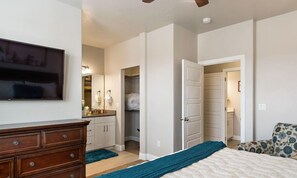 A bedroom with a bed, a dresser, a TV, a closet, and a bathroom. - About Time- Pool is Open! 32 Miles to Zion (Washington)