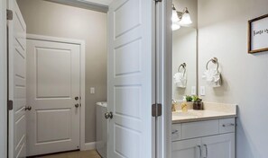A bathroom with a white vanity, a mirror, and a framed quote on the wall. - About Time- Pool is Open! 32 Miles to Zion (Washington)