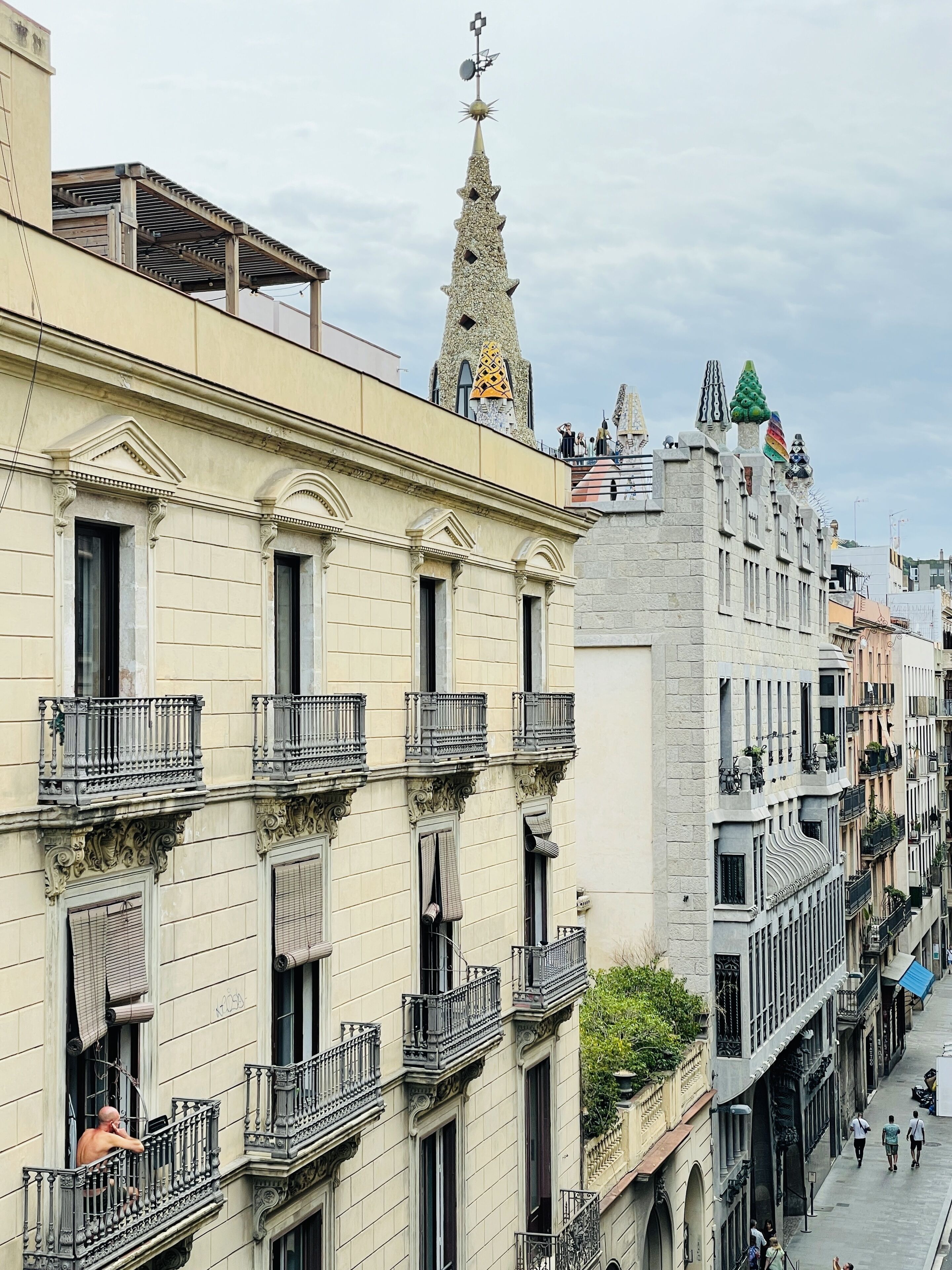 A multi-story building with ornate balconies and a decorative tower.
