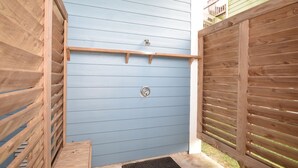 A wooden fence with a metal gate, a wooden bench, and a metal doormat. - Luxury in Crystal Beach~ 4/3 ~ Beautiful Beach Views~Direct beach access (Crystal Beach)