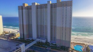A high-rise hotel with multiple floors, a swimming pool, and a beach view. - Beach Front Property in Panama City Beach Florida (Panama City Beach)