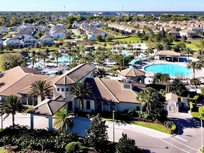A residential area with a large swimming pool, multiple houses, and palm trees. - Movie Nights on the Big Screen! MEGA Fun in VERY Private Pool! 1444 (Davenport)