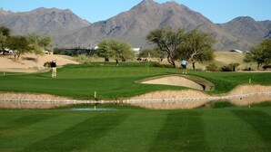 A golf course with a pond, trees, and mountains in the background. - Golf & Baseball Batting Cage/ Hot Tub/ Luxurious Living/ Private, Gated, Quiet (Scottsdale)