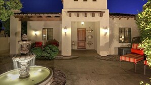 A building with a courtyard, a fountain, and outdoor seating. - Golf & Baseball Batting Cage/ Hot Tub/ Luxurious Living/ Private, Gated, Quiet (Scottsdale)