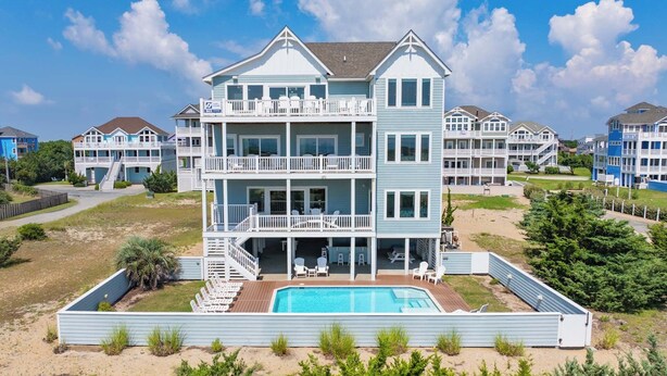 A multi-story beachfront property with a swimming pool, balconies, and a beach access area. - Premier Dog-Friendly Oceanfront 9BR w/ Private Pool, Tiki Bar, Theater, Elevator (Salvo)