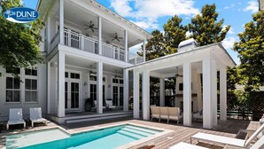 A two-story house with a pool, outdoor seating, and a covered patio area. - WaterColor Luxury on 30A! 63 Western Lake, Park District, Pool, 7 Bdrms, Slps 16+ (Santa Rosa Beach)