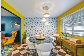 Relax in the dining area with a round table and comfortable seating for all.