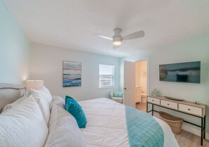 A bedroom with a bed, a ceiling fan, a window with blinds, a TV mounted on the wall, and a dresser. - "Eastern Shores 206" | Beachfront| Pristine Beach Views |  2 Bikes included (Santa Rosa Beach)
