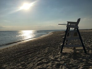 A beach with a lifeguard chair and a clear view of the ocean.