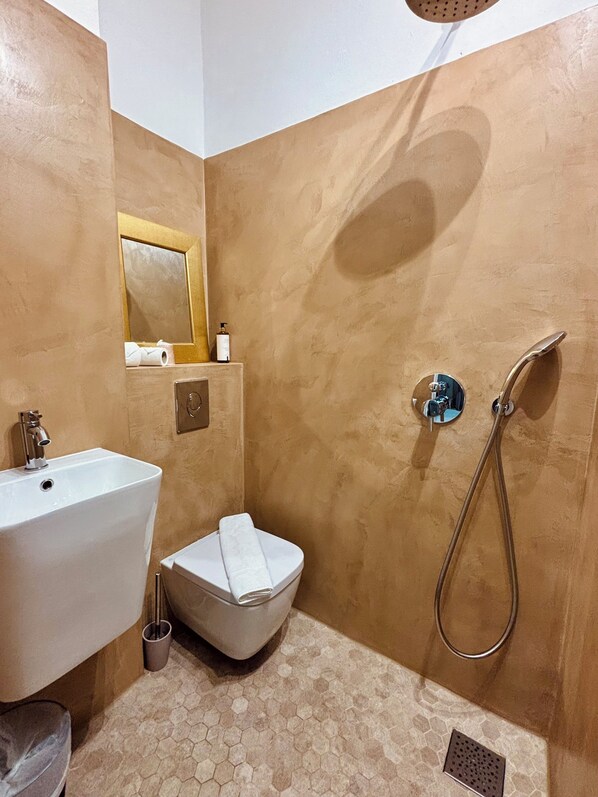 A bathroom with a sink, toilet, and shower.