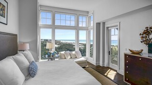 A bedroom with a large bed, a dresser, and a view of the ocean. - Gulf Front Penthouse Condo * Complimentary LSV 407 Compass Point 1, WaterSound - 3 BR, SLPS 8 (Panama City Beach)
