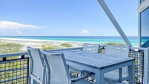 A balcony with a table and chairs overlooking a beach. - Gulf Front Penthouse Condo * Complimentary LSV 407 Compass Point 1, WaterSound - 3 BR, SLPS 8 (Panama City Beach)