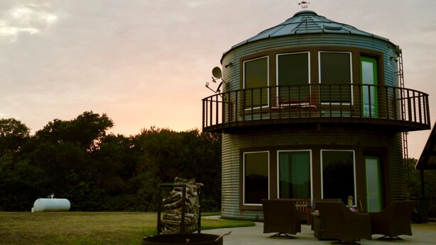 A cylindrical building with a balcony, large windows, and outdoor seating. - Country get away in Waxahachie, TX on 10 acres Shared with The Yurt in the Woods (Waxahachie)