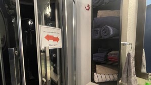 A modern bathroom with a glass door, a towel rack, a sink, and a mirror. - Country get away in Waxahachie, TX on 10 acres Shared with The Yurt in the Woods (Waxahachie)