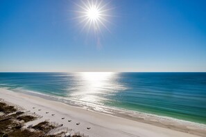 A beach with a clear sky and the sun shining brightly. - Charming Beach Cottage, 2 Golf Carts! Beautiful Views, Pool, Hot Tub, Fitness (Miramar Beach)