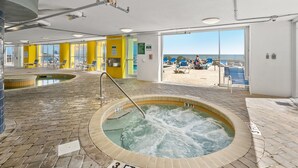 An indoor swimming pool with a 3 FT depth sign, yellow walls, and a view of the beach. - Seaside Resort 1003 3 Bedroom Condo by RedAwning (North Myrtle Beach)