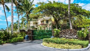 A tropical resort with a gated entrance, lush greenery, and a stone wall with the resort's name. - Fairway S Waikoloa A21 2 Bedroom Condo by RedAwning (Waikoloa)