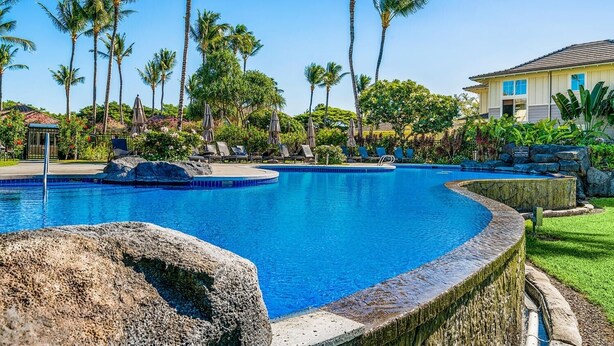 A swimming pool with lounge chairs and palm trees. - Fairway S Waikoloa A21 2 Bedroom Condo by RedAwning (Waikoloa)