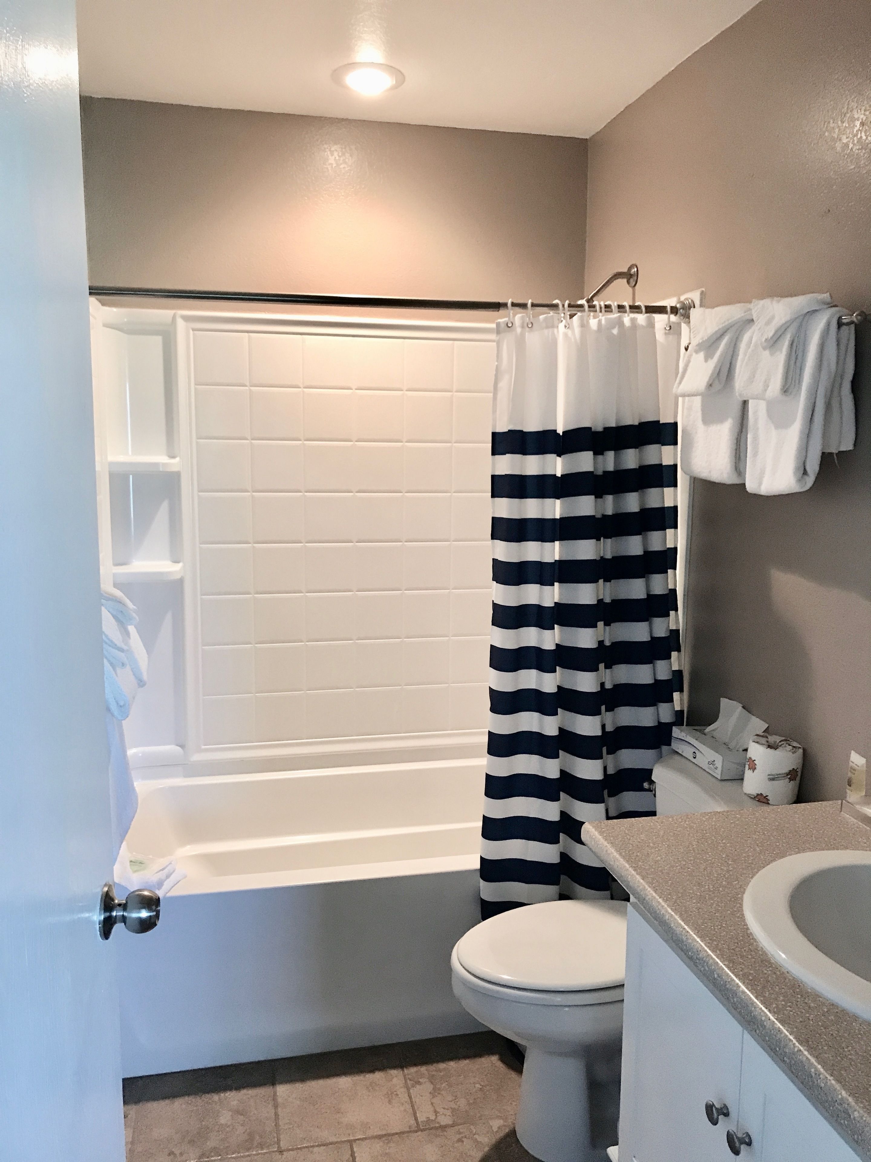 A bathroom with a bathtub, a toilet, and a sink.