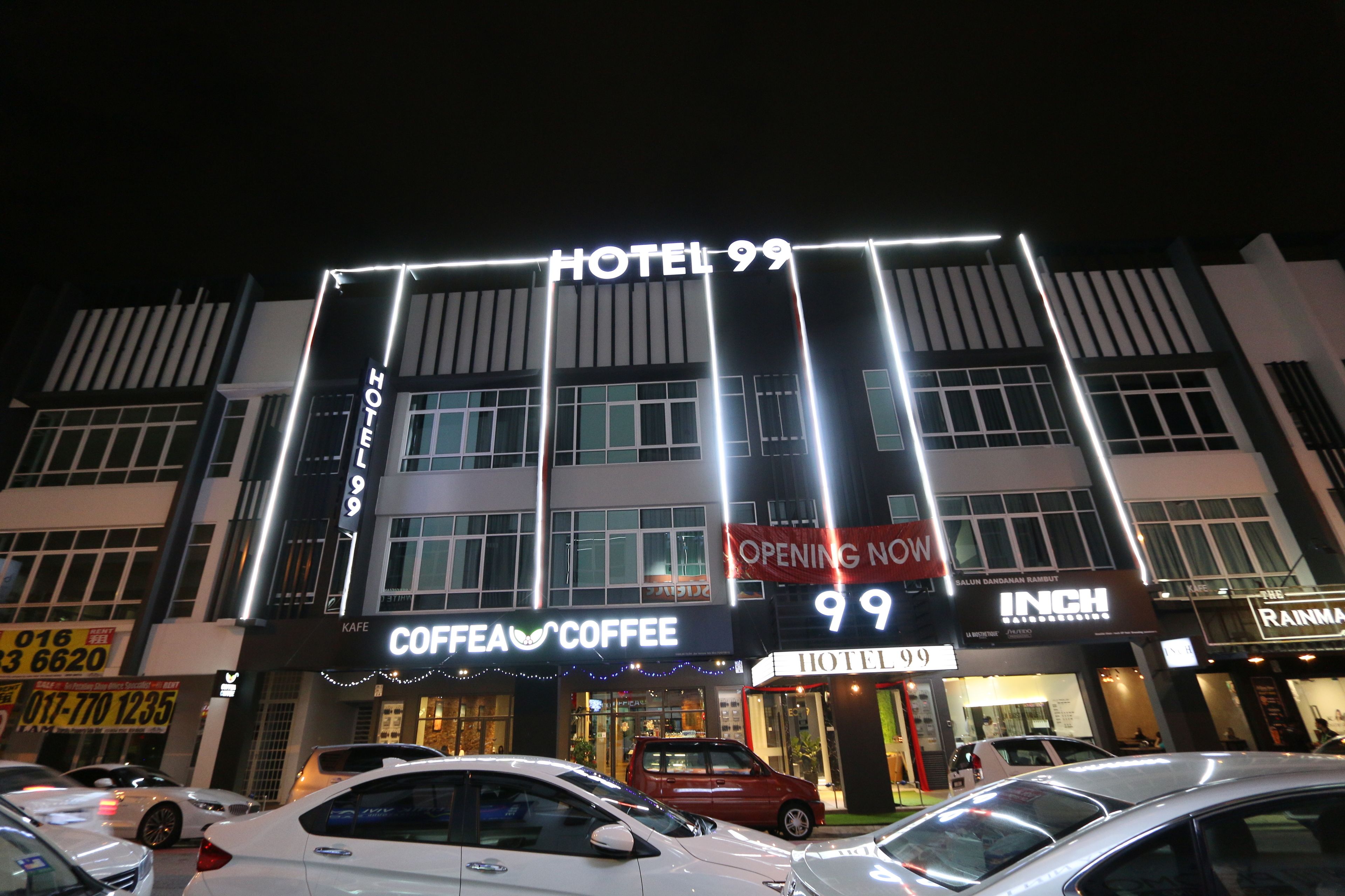 A hotel with a sign reading "HOTEL 99" and "COFFEE COFFEE" on the ground floor.