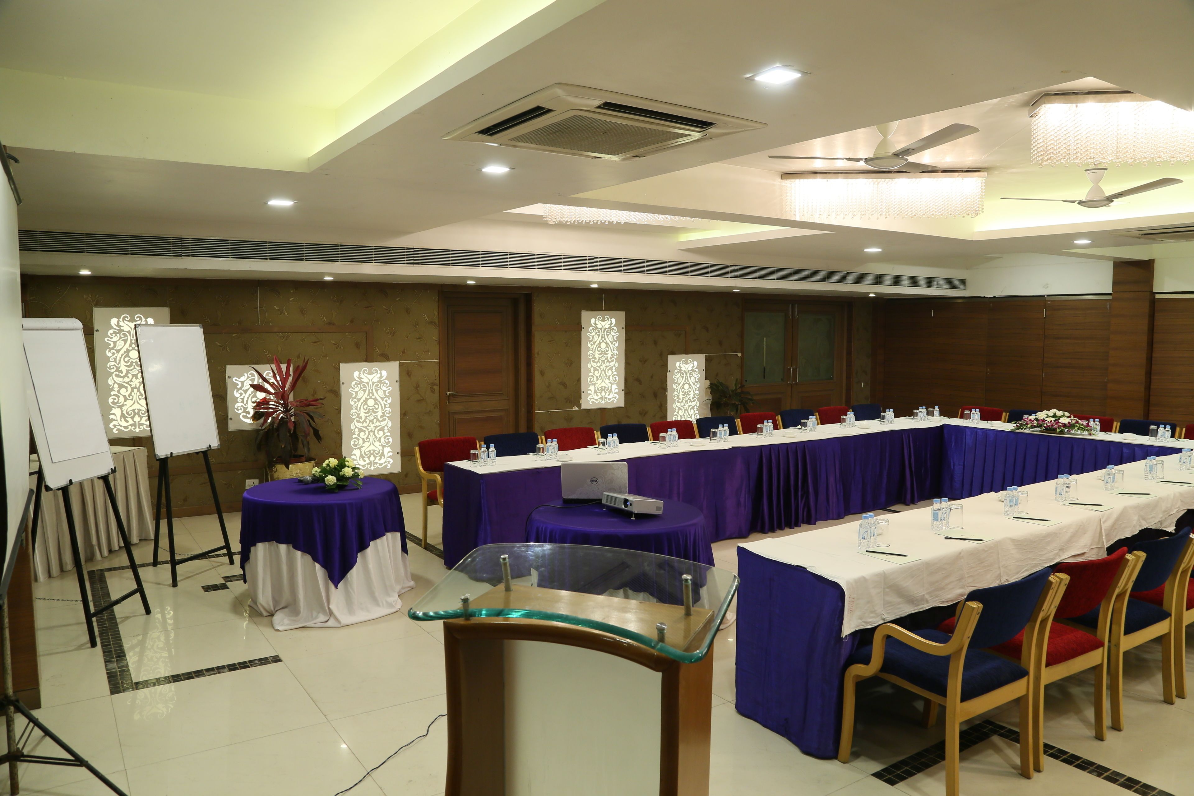 A conference room with a long table, chairs, and a whiteboard.