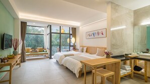 A modern hotel room with two beds, a wooden desk, a large window with a view, and a bathroom with a mirror and sink. - CTN LiRiver Boutique Hotel (Guilin)