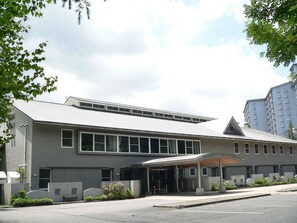 A modern building with a flat roof, large windows, and a covered entrance area. - Kusatsu Green Park Palace (Kusatsu)
