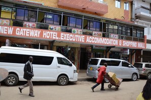 A hotel with a sign for "New Gateway Hotel, Executive Accommodation & Shopping Mall".