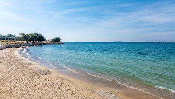 On the beach, white sand, sun loungers, beach umbrellas