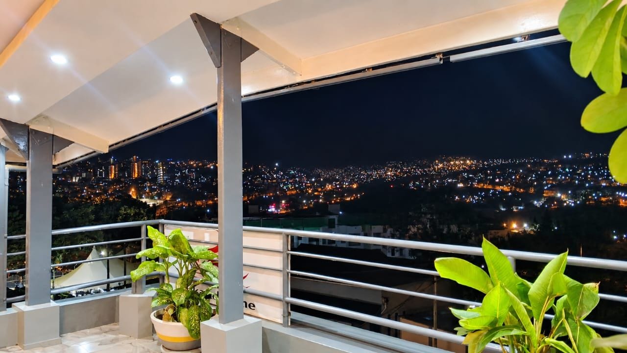 A balcony with a city view at night.