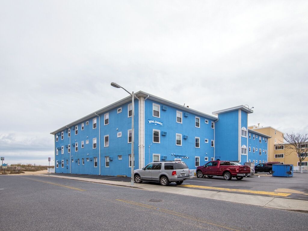 A blue building with multiple windows and a sign that reads "WIND JAMAICA".