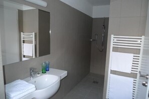 A bathroom with a white sink, mirror, and towel rack. - Hotel Stifter (Valle Aurina)