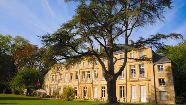 A large, historic building with a symmetrical facade, multiple windows, and a prominent tree in front. - Château de Grand Tonne (Thue et Mue)