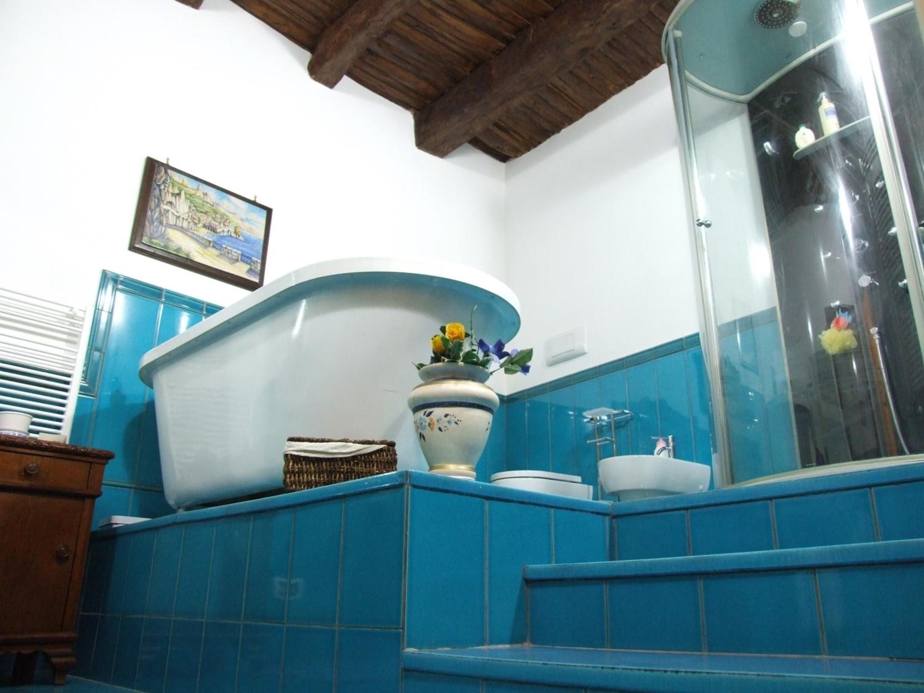 A bathroom with a bathtub, a toilet, and a shower.