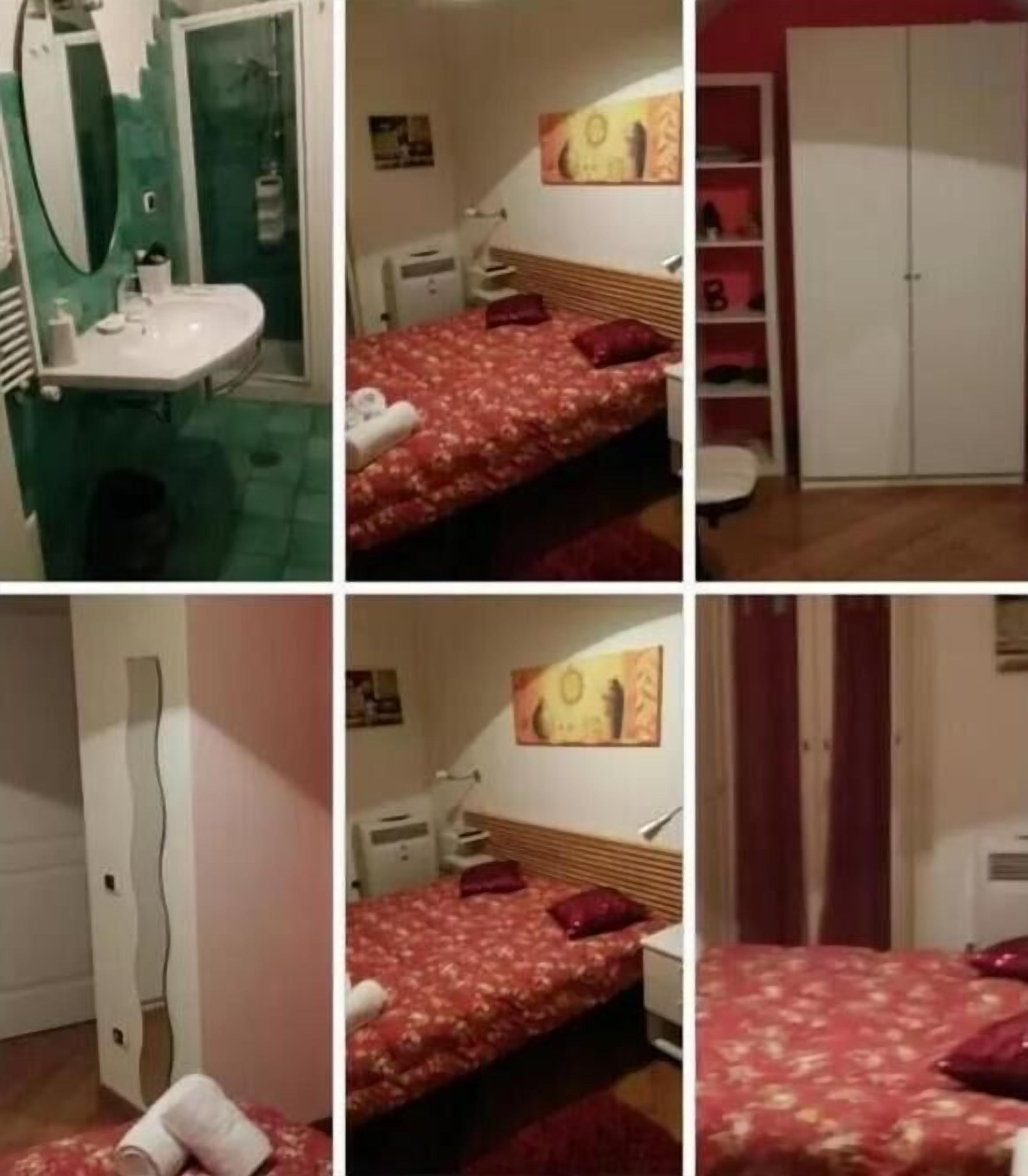A bedroom with a bed, a nightstand, a wardrobe, and a bathroom with a sink and mirror.