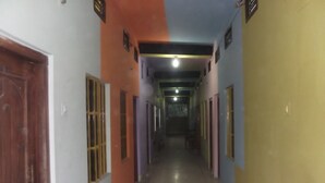 A corridor with doors on both sides, leading to rooms. - Azmiry Residential Hotel (Kushtia)