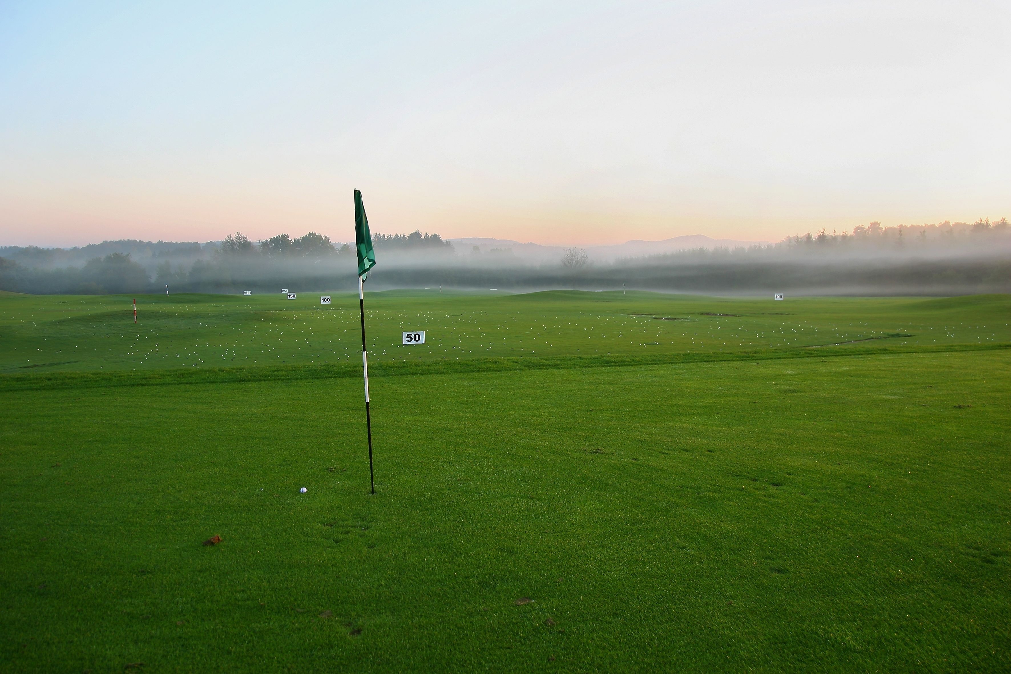 Ein Golfplatz mit Fahnenstange und nummerierten Markern.