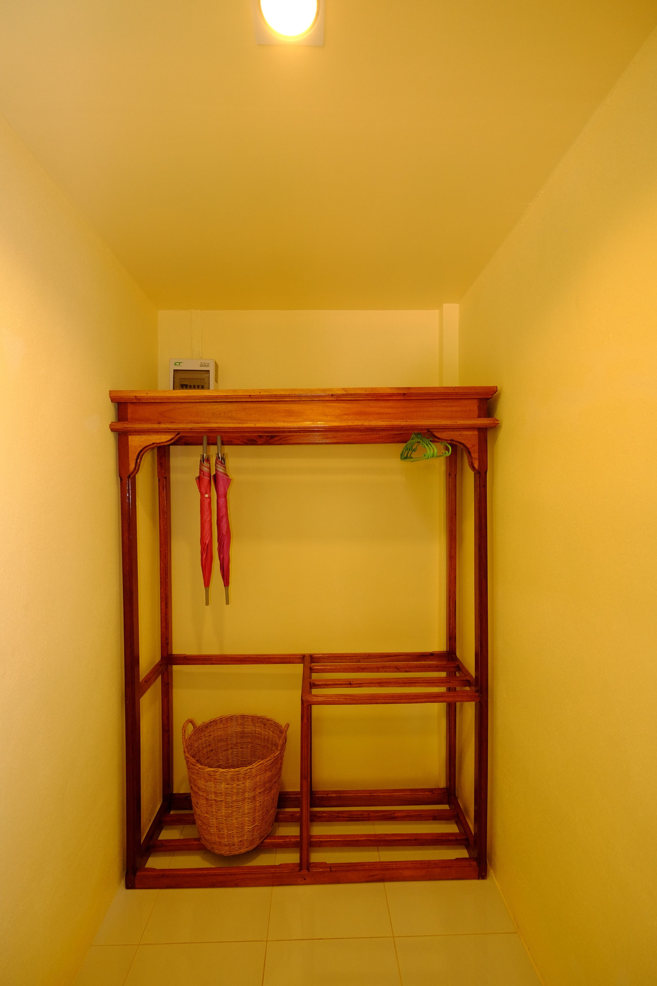 A small, enclosed room with a wooden bench and a wicker basket.