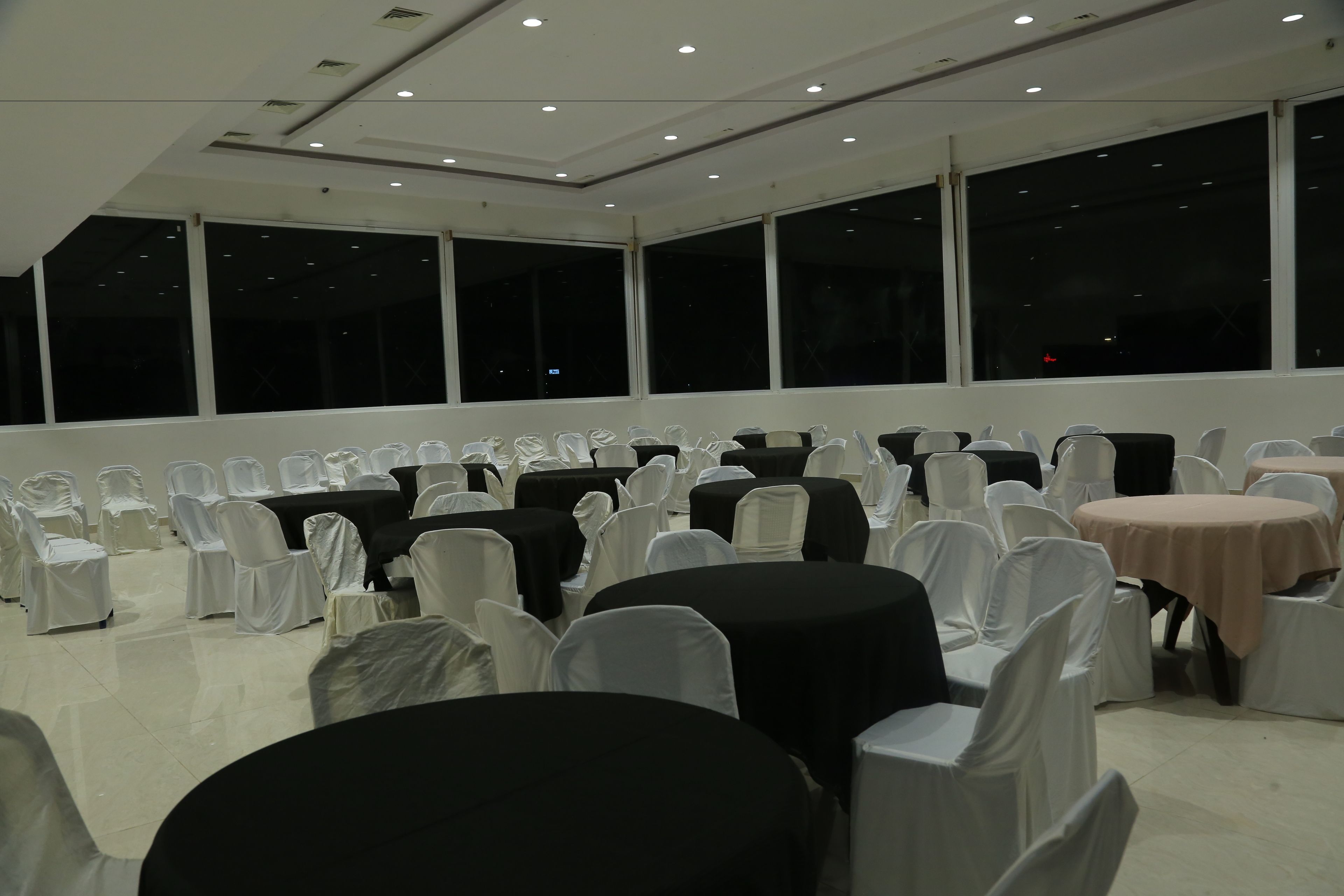A conference room with tables and chairs arranged for a meeting.