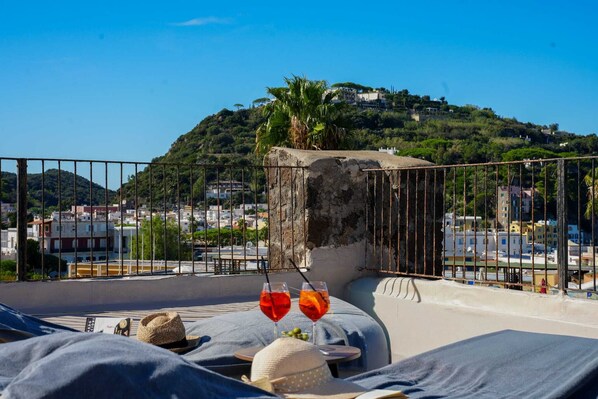 Terraza en la azotea con vistas a una colina y al paisaje urbano.
