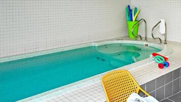 Relax by the pool, surrounded by a serene atmosphere and amenities for a comfortable stay.