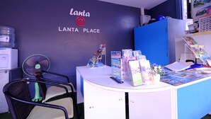 A reception desk with a sign reading "Lanta Place" and a blue cabinet. - Lanta at Lanta Place (Ko Lanta)